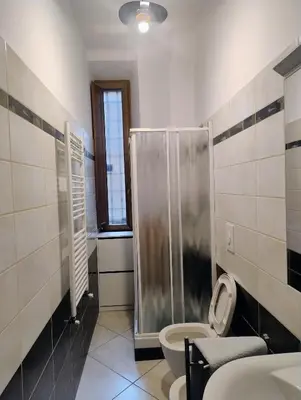 a bathroom with a shower and a toilet in it at Casa del Vinile Roma in Rome