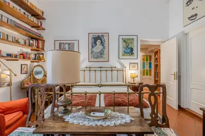 a living room with a bed and a table at Your cozy place at the Vatican in Rome