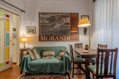 a living room with a green couch and a table at Your cozy place at the Vatican in Rome