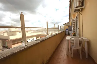 a balcony with a table and a view of a building at Manuela Holiday House in Rome