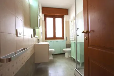 a bathroom with a toilet and a sink and a window at Manuela Holiday House in Rome