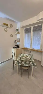 a dining room with a table and chairs in a room at Leone Bed & Dreams in Rome