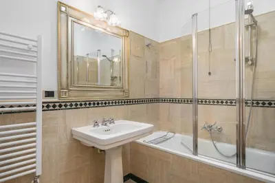a bathroom with a sink and a shower at Colosseum Monti large flat in Rome