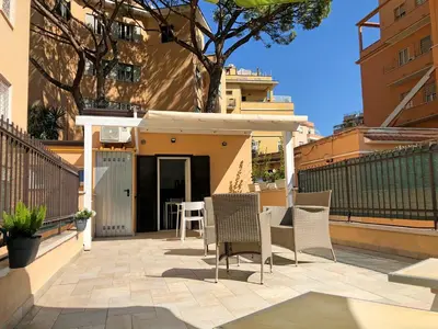 a patio with chairs and a table in front of a building at Wonderful little gem with a large private terrace! in Rome