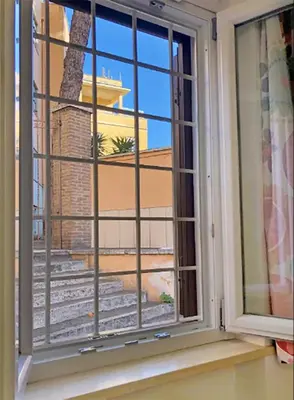 a window with a view of a building at Wonderful little gem with a large private terrace! in Rome