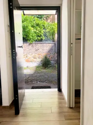 an open door with a view of a brick wall at Wonderful little gem with a large private terrace! in Rome