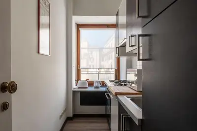 a small kitchen with a sink and a window at GuestHost - Roma MM Repubblica Apartment in Rome