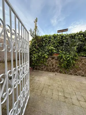 a white gate in front of a stone wall at La Martinella a Roma in Rome