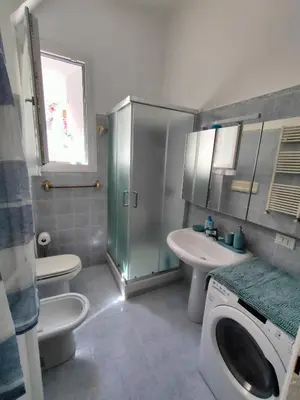 a bathroom with a toilet sink and a washing machine at Romein5minutes in Rome
