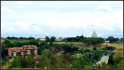 a view of a city with a building and a dome at Il Cupolone in Pineta - Two steps in the pinewood towards the Vatican! in Rome