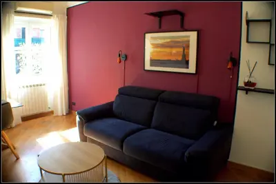 a living room with a couch and a table at Il Cupolone in Pineta - Two steps in the pinewood towards the Vatican! in Rome