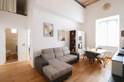 a living room with a couch and a table at Lux San Pietro Apartment in Rome