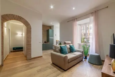a living room with a couch and a table at GuestHost - Domus Antoniana - Esquilino in Rome