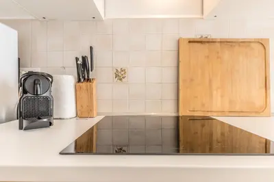 a kitchen with a counter top with a sink at Casa Nina Ostiense - Roma Tre - by GHOR in Rome