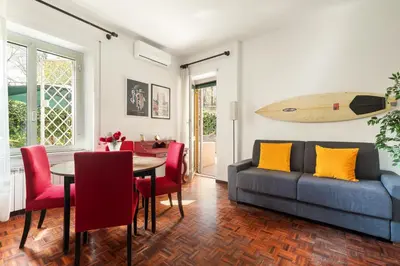 a living room with a couch and a surfboard on the wall at San Paolo Private Garden Home in Rome