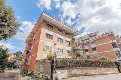 an apartment building with a fence in front of it at Luxury Maison Dei Colli in Rome