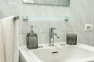 a bathroom sink with a soap dispenser on it at Domus Bonadies - Musei Vaticani - San Pietro in Rome