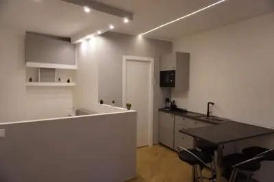 a kitchen with a counter and a table and chairs at Tito Livio Vatican Home in Rome