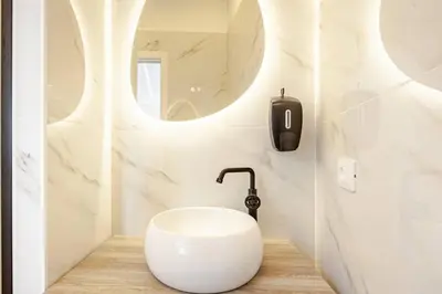 a bathroom with a white sink and a mirror at Tito Livio Vatican Home in Rome