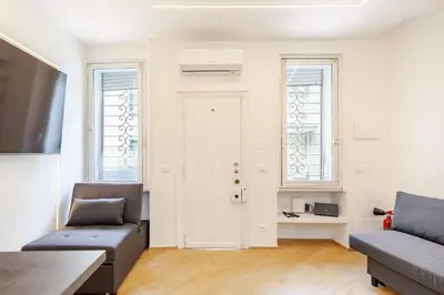 a living room with two couches and a table at Tito Livio Vatican Home in Rome