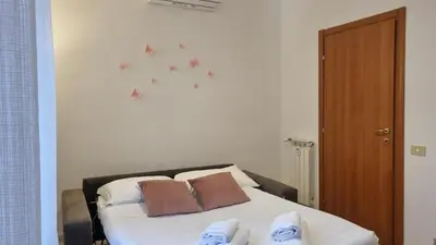 a bedroom with a bed with two pillows on it at At the Pope's bridge in Rome