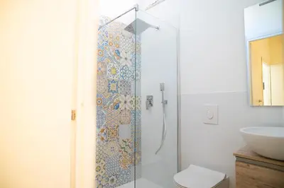 a bathroom with a shower with a toilet and a sink at Modern two-room apartment for 2, 20 minutes from Termini in Rome