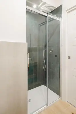 a shower with a glass door in a bathroom at Smeraldo Vatican Moments in Rome