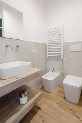 a white bathroom with a sink and a toilet at Smeraldo Vatican Moments in Rome