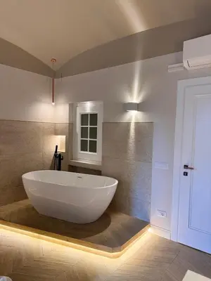 a large white bath tub in a bathroom at Residenza Vittorio Veneto in Rome