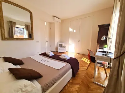 a bedroom with a large bed and a mirror at Boutique Domus Charme Trastevere Vascellari in Rome
