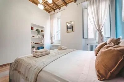 a bedroom with a large bed with towels on it at Fancy Colosseum - Best location in Rome