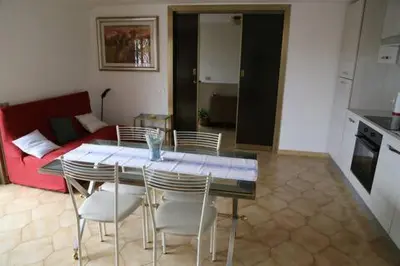 a kitchen with a table and chairs and a couch at Super attico Eur in Rome