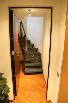 a hallway with a staircase in a house at Super attico Eur in Rome