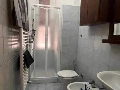 a bathroom with a shower with a toilet and a sink at Domus Ele in Rome