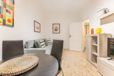 a living room with a table and a couch at La Casetta Furio Camillo in Rome