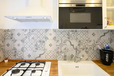 a kitchen with a stove top and a sink at Toto Vatican Suite in Rome