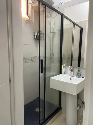a bathroom with a glass shower and a sink at Ines Guest House in Rome