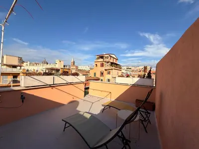 a balcony with two chairs and a view of a city at Monti View Apartment in Rome