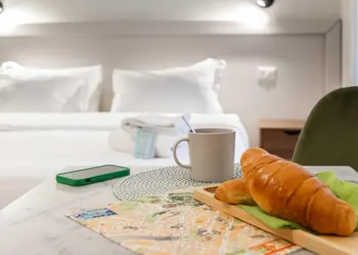 a table with a cup of coffee and a loaf of bread at Rental in Rome Guest House 2-ZEN51 in Rome