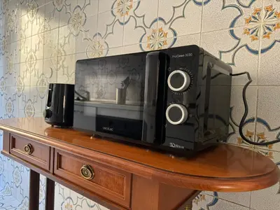 a microwave sitting on top of a table at Piramide-Ostiense Two Bedroom Apartment in Rome