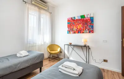 a bedroom with two beds and a chair and a painting at Vaticano-Metro A 1 min, Urban Rooftop in Rome