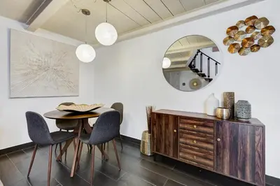a dining room with a table and chairs and a mirror at Trastevere Piazza Trilussa Royal Orchid apartment in Rome