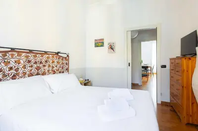 a bedroom with a white bed with towels on it at Belle Arti Zen Apartment- Cale 03 in Rome