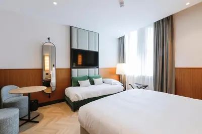a hotel room with a bed and a desk and a table at Circle6 Rome in Rome