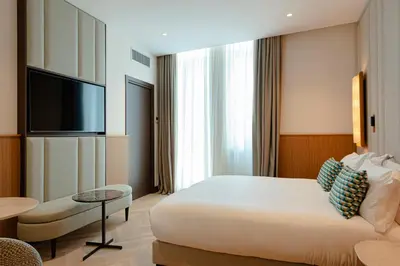 a hotel room with a bed and a flat screen tv at Circle6 Rome in Rome