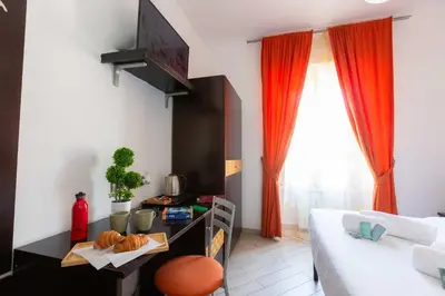 a living room with red curtains and a couch at Rental in Rome Guest House - ZEN01 in Rome