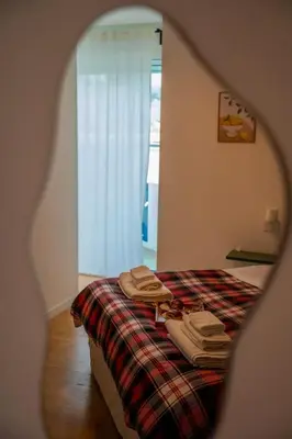 a green plant in a room with a bed at Labicant Casa Vacanze Roma in Rome