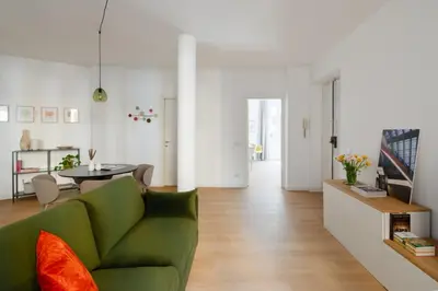 a living room with a green couch and a table at Aeterna Suites Roma in Rome