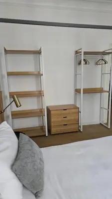 a bedroom with a bed and shelves and a bed sidx sidx sidx at Aeterna Suites Roma in Rome