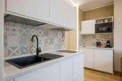 a kitchen and living room with a couch and a table at Aurelius Design Loft 1 in Rome